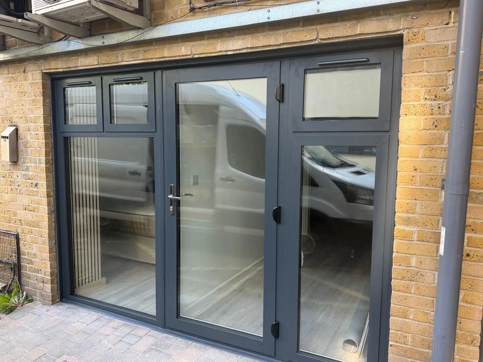 Anthracite aluminium French doors with toplights, fitted to a ground-floor flat