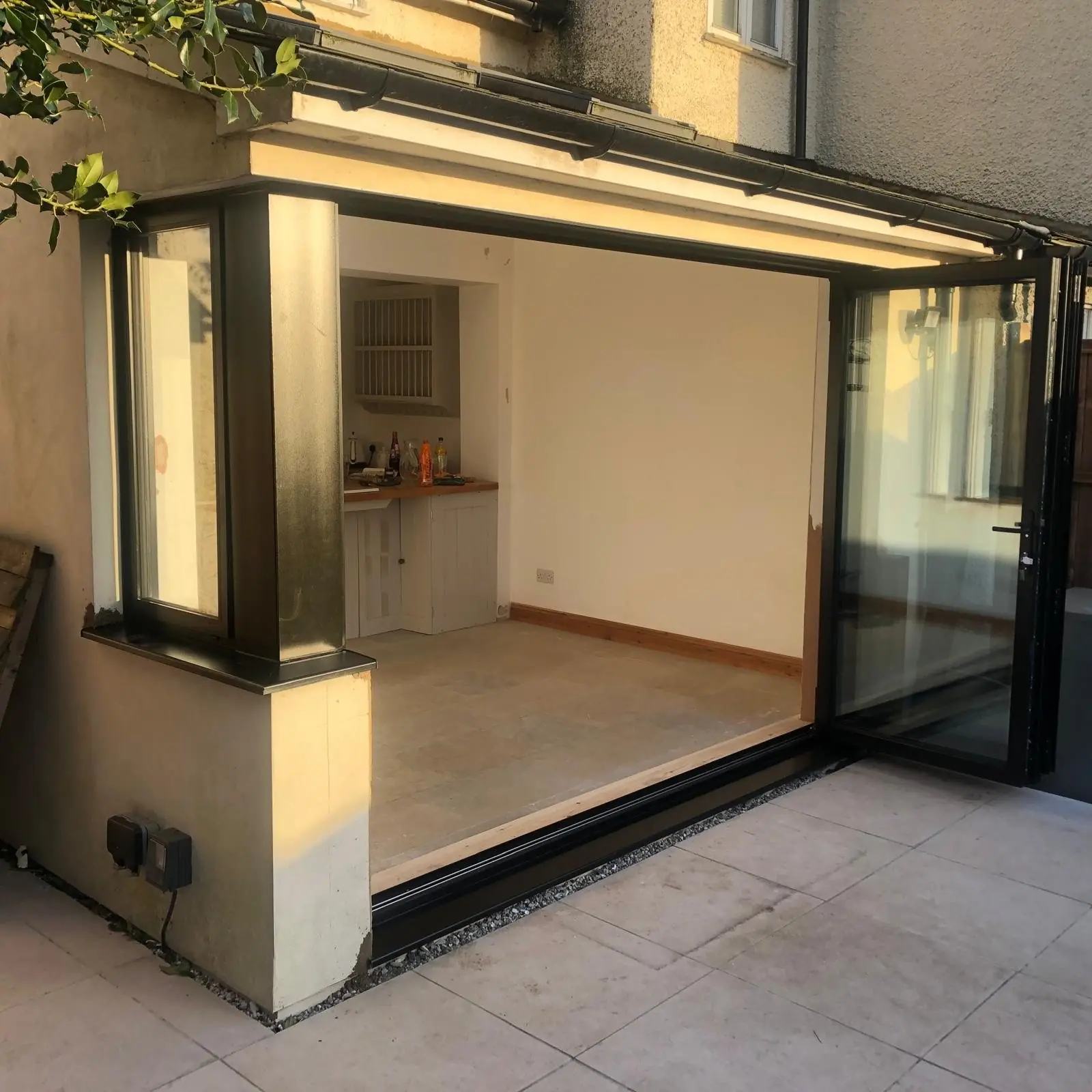 Black aluminium corner bifold doors, open