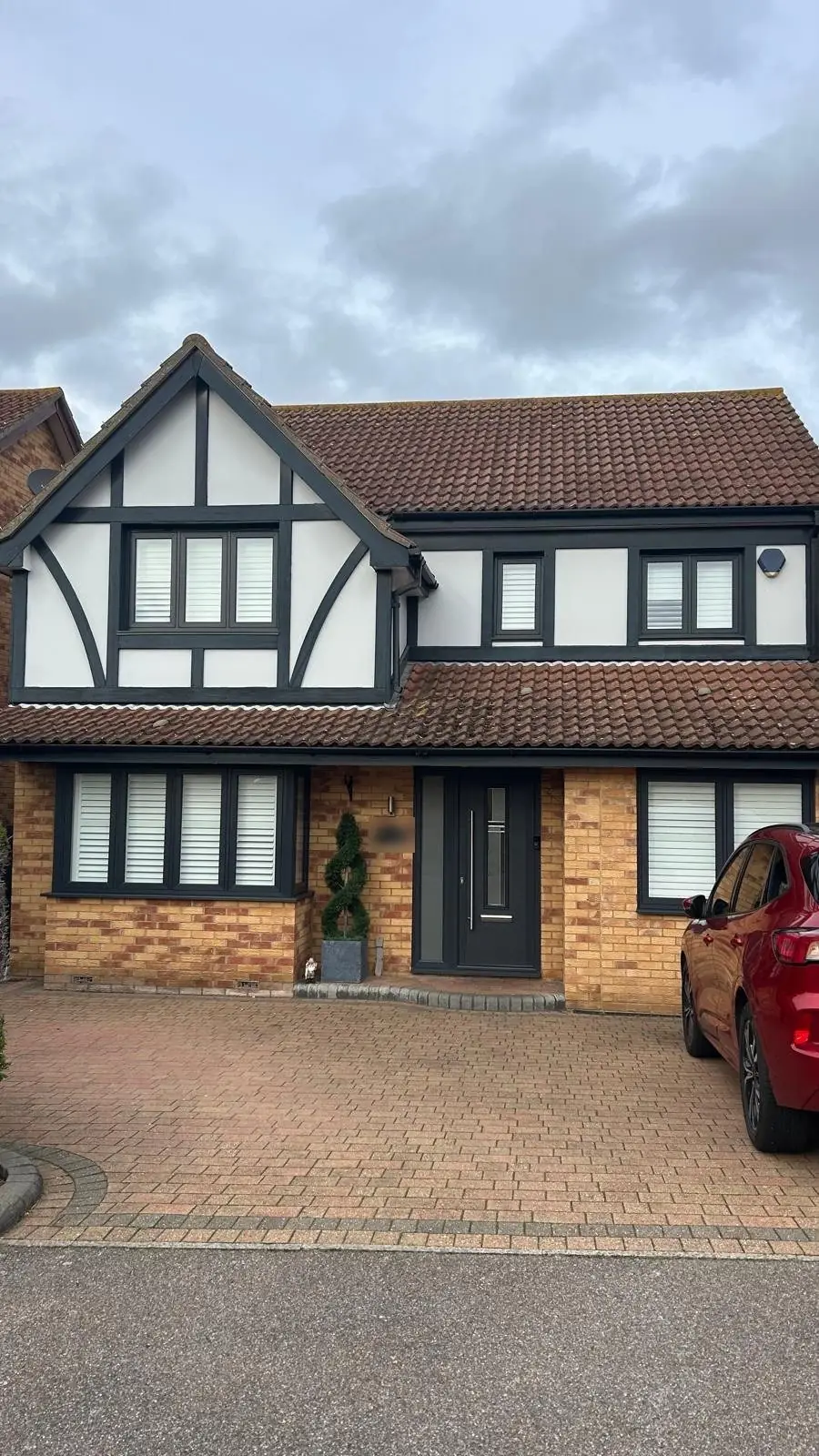 Anthracite grey windows and door on a Tudor-style house